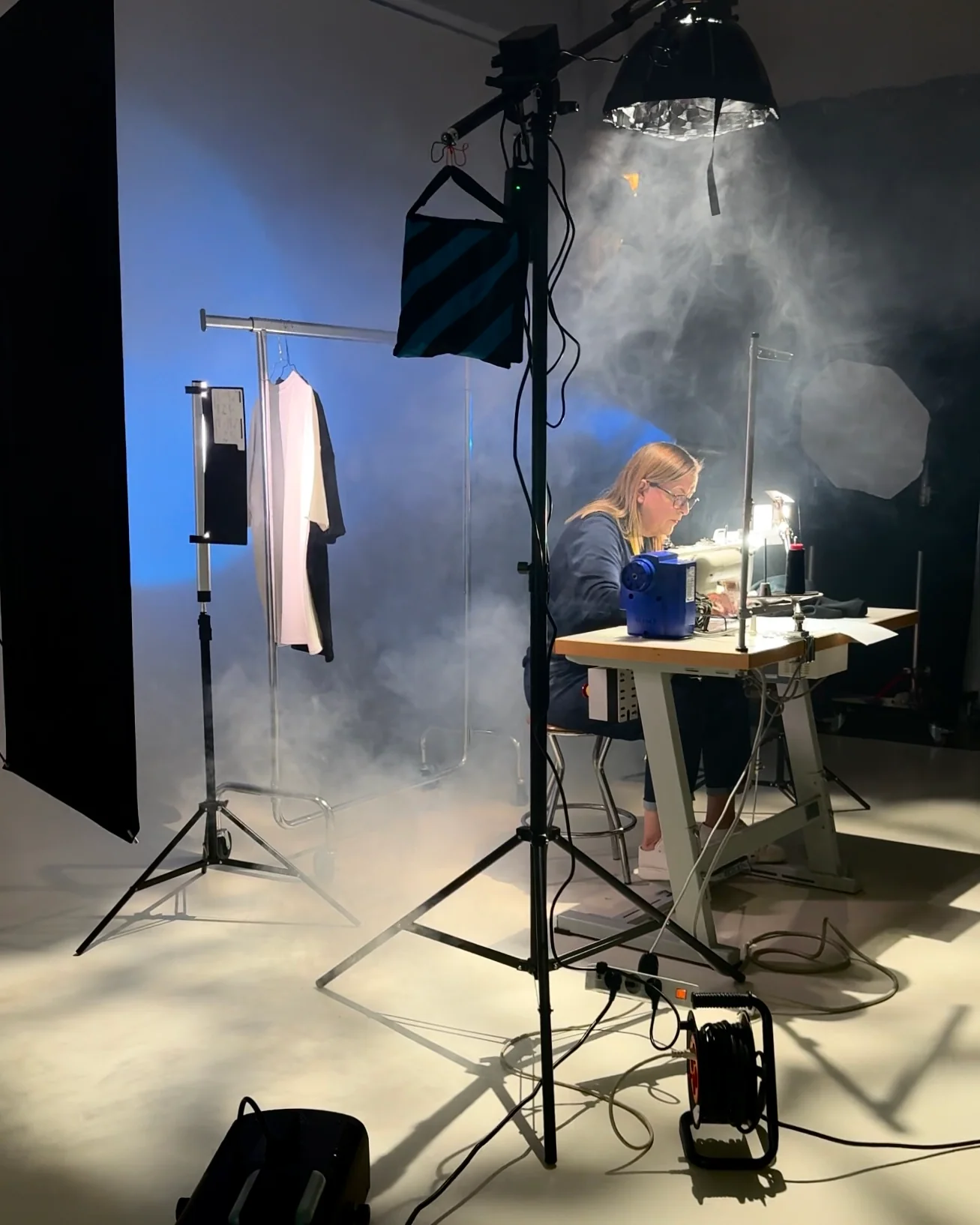 Set creativo con macchina da cucire, luci e fumo scenico
